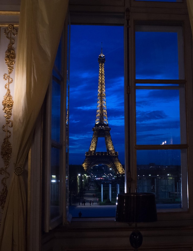 An open window shows a night view of the Eiffel Tower in Paris, Sept. 18, 2014.  
