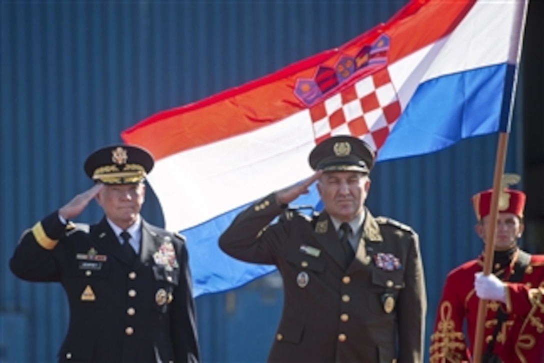 U.S. Army Gen. Martin E. Dempsey, left, chairman of the Joint Chiefs of Staff, and Croatian Gen. Drago Lovric, chief of Croatia's general staff, salute during a ceremony at the Zagreb Airport in Croatia, Sept. 21, 2014