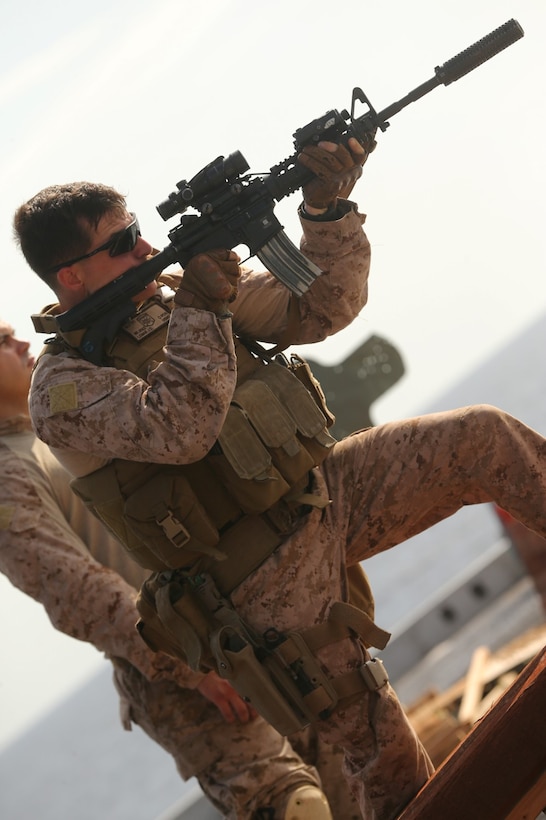 Marines with the scout sniper platoon, Battalion Landing Team 2nd Battalion, 1st Marines, 11th Marine Expeditionary Unit (MEU), fire at targets from the rear of the flight deck of the amphibious transport dock ship USS San Diego (LPD 22) while underway.  San Diego is part of the Makin Island Amphibious Ready Group and, with the embarked 11th MEU, is deployed in support of maritime security operations and theater security cooperation efforts in the U.S. 5th Fleet area of responsibility. (U.S. Marine Corps photo by Cpl. Jonathan R. Waldman/Released)