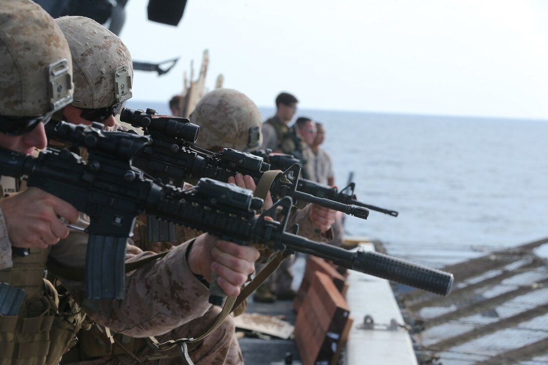 U.S. Marines with the scout sniper platoon, Battalion Landing Team 2nd Battalion, 1st Marines, 11th Marine Expeditionary Unit (MEU), fire at targets from the rear of the flight deck of the amphibious transport dock ship USS San Diego (LPD 22) while underway. San Diego is part of the Makin Island Amphibious Ready Group and, with the embarked 11th MEU, is deployed in support of maritime security operations and theater security cooperation efforts in the U.S. 5th Fleet area of responsibility. (U.S. Marine Corps photo by Cpl. Jonathan R. Waldman/Released)