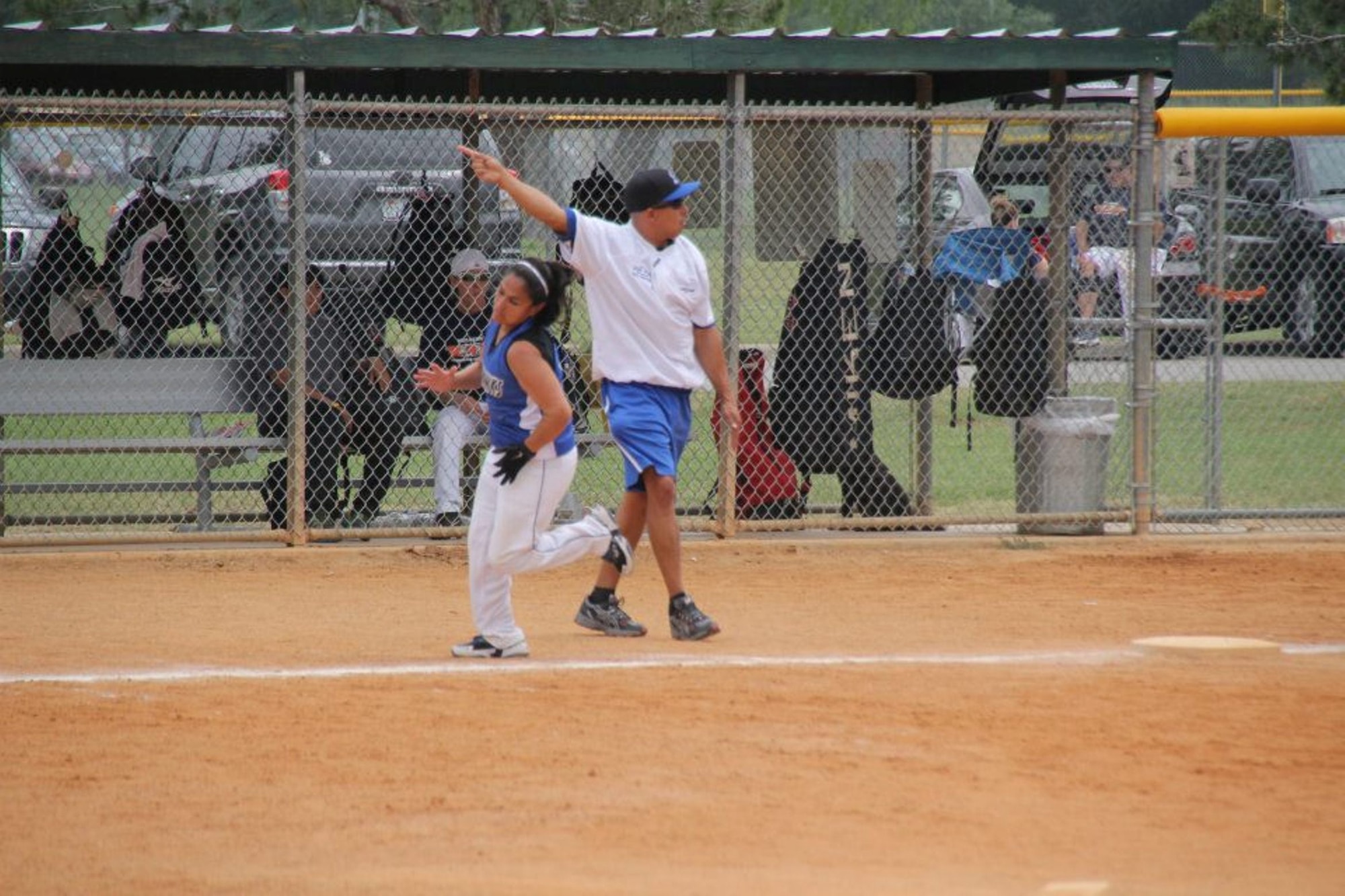 Third base coach Salomon Vieyra sends a runner home during a womens softball game. The first year head coach lead the All-Air Force Women's team to its first Armed Forces title since 2011 on Sept. 18 at Fort Sill, Okla. (Courtesy photo) 
