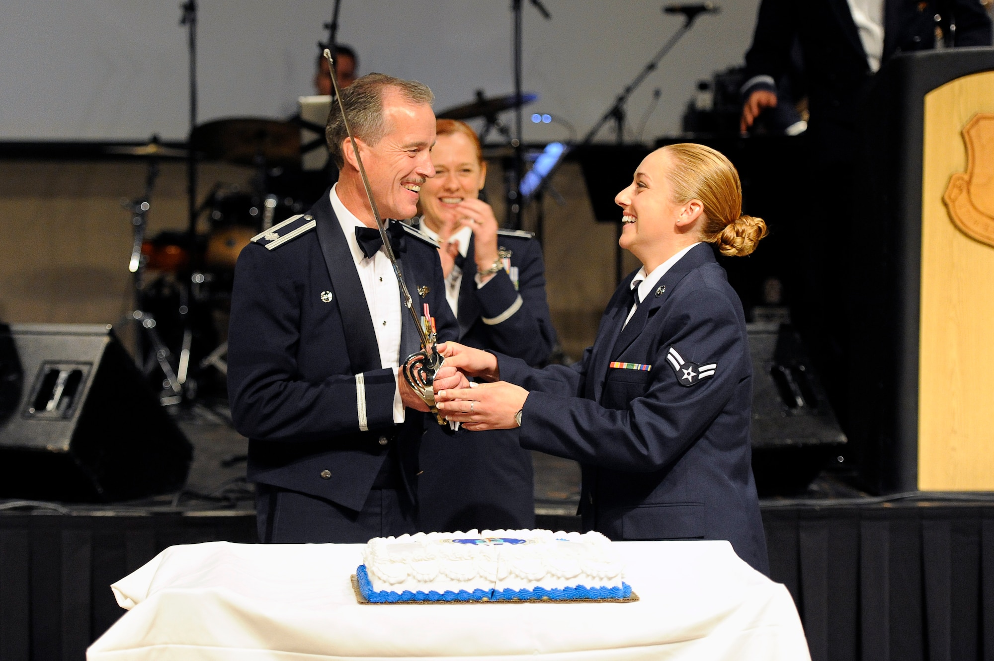 SAN ANGELO, Texas – Lt. Col. Paul T. Miller Jr., senior Air Force Ball attendee, and Airman 1st Class Helen M. Bender, junior Air Force Ball attendee, complete the cake cutting ceremony as Col. Kimberlee P. Joos, 17th Training Wing Commander, applauds at the McNease Convention Center Sept. 19. The ball attendees celebrated 67 years of Air Force heritage. (U.S. Air Force photo/ Staff Sgt. Austin Knox)   