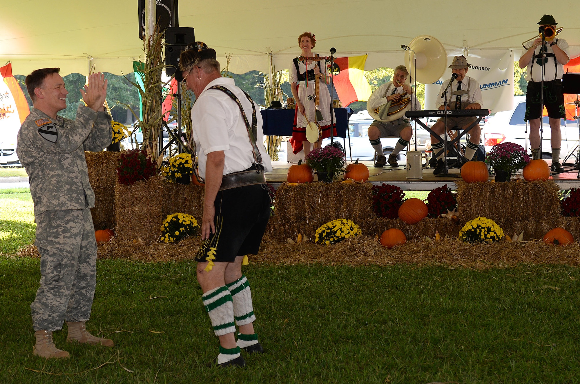 U.S. Army Col. William Galbraith, 733rd Mission Support Group commander, learns a traditional German dance from a member of The Happy Dutchmen during the annual Oktoberfest celebration at Fort Eustis, Va., Sept. 19, 2014. More than 900 members of the Fort Eustis community came out for the festival to celebrate the beginning of the fall season. (U.S. Air Force photo by Staff Sgt. Teresa J. Cleveland/Released)