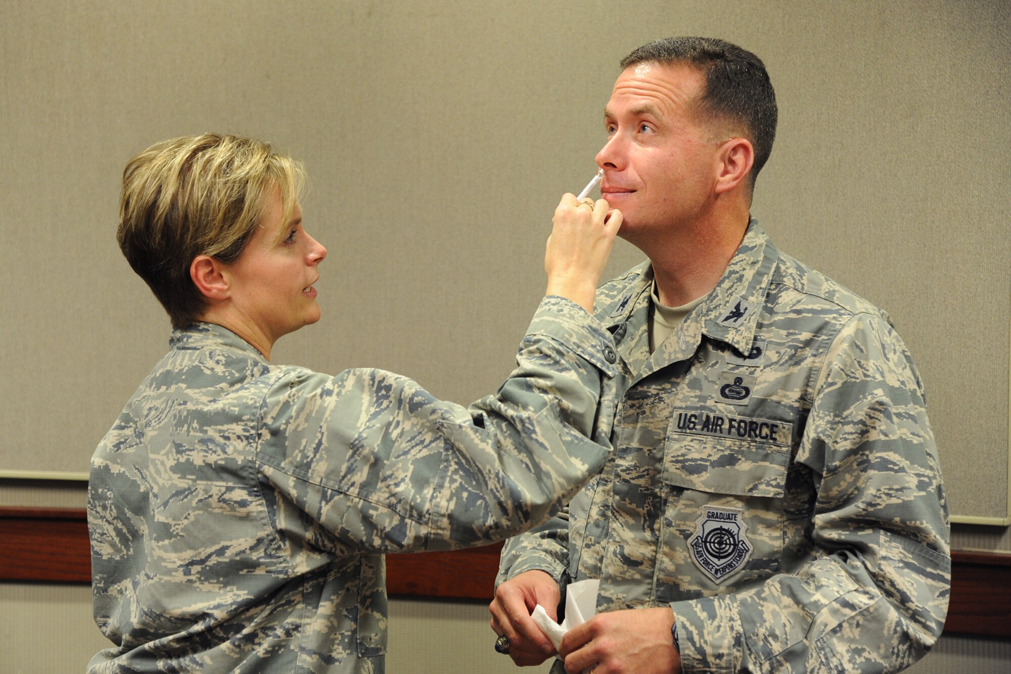 GOODFELLOW AIR FORCE BASE, Texas – Col. Michael Grunwald, 17th Training Group commander, receives his flu vaccination by Maj. Nikki D. Robinson, 17th Medical Operations Squadron clinical medicine flight commander, at the Norma Brown building Sept. 23. All active duty military members are required to receive the flu vaccination annually. (U.S. Air Force photo/ Airman 1st Class Devin Boyer)