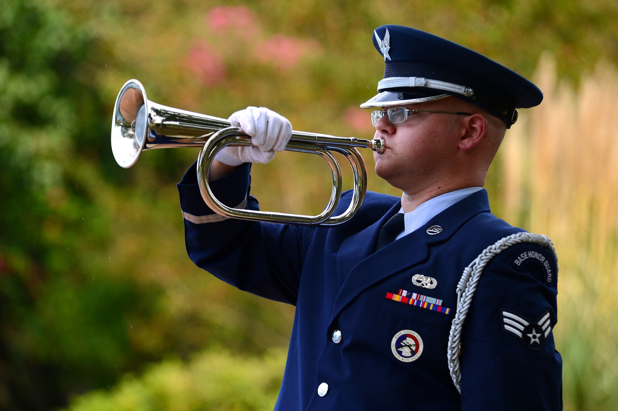 U.S. Air Force Senior Airman Nicholas Macdonald, 20th Force Support Squadron Honor Guard member, simulates playing taps during a POW/MIA Remembrance Day ceremony at Shaw Air Force Base, S.C., Sept. 19, 2014. Along with taps, the 20th FSS Honor Guard performed a 3-volley rifle salute during the ceremony. (U.S. Air Force photo by Airman 1st Class Jensen Stidham/Released)