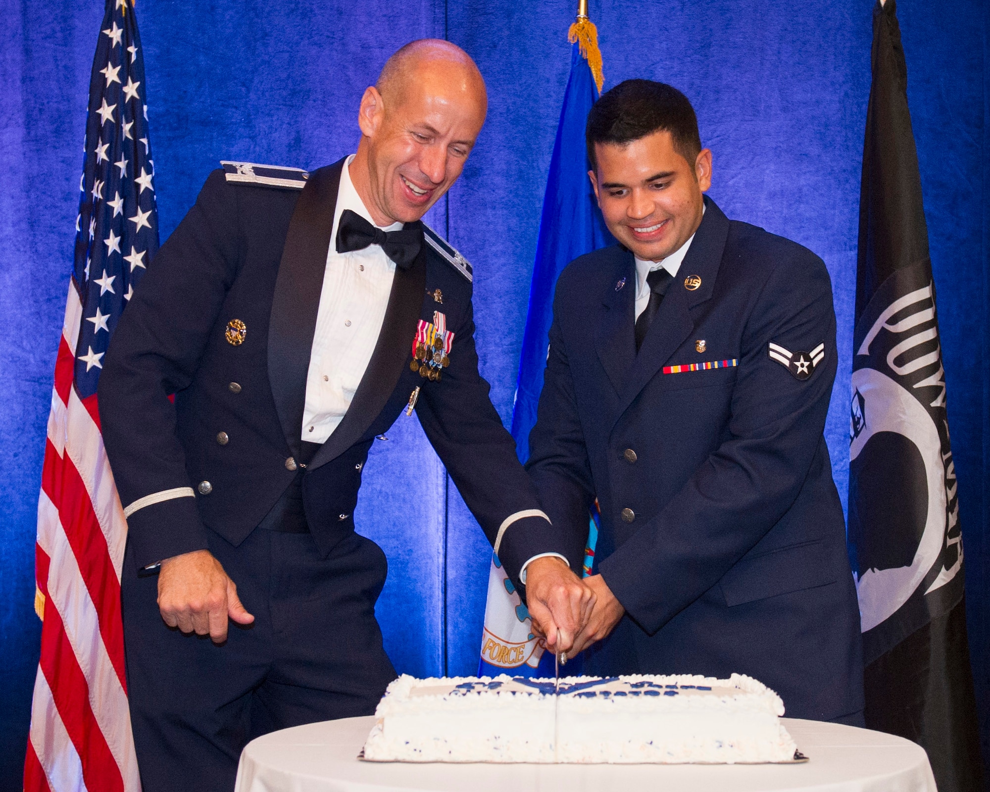 (left) Col. James Denbow Jr., Air Force Technical Applications Center, and Airman 1st Class Juan Monsalve, 45th Aerospace Medical Squadron, cut an Air Force birthday cake, Sept. 19, 2014, during the Air Force Ball in Melbourne, Fla. Denbow was the longest serving active-duty member and Monsalve was the most junior enlisted, in attendance. (U.S. Air Force photo/Matthew Jurgens) (Released) 