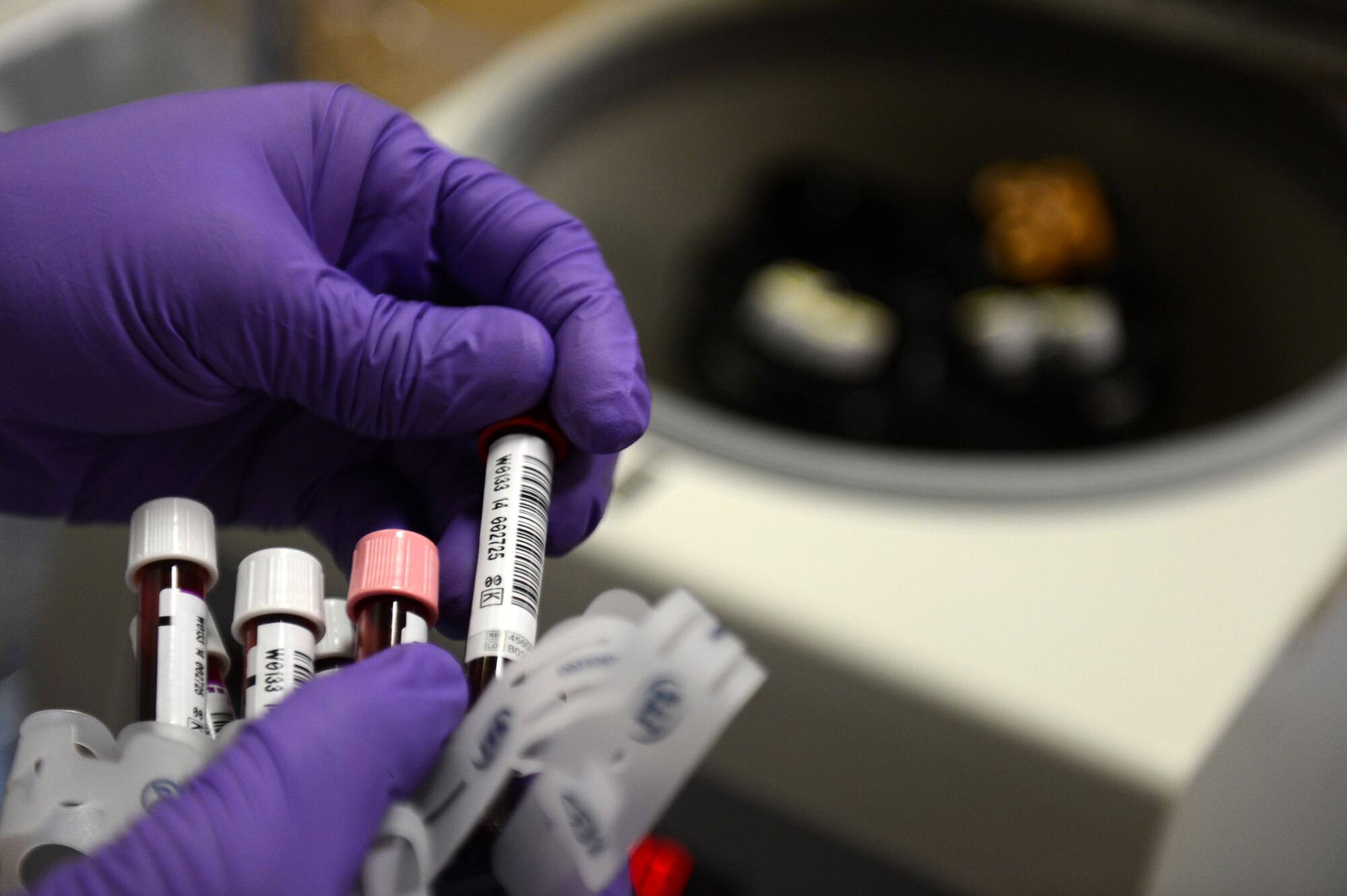 U.S. Army Sgt. Erik Addo, a Landstuhl Regional Medical Center technician  and native of Ghana, places vials of blood in a centrifuge during an Armed Services Blood Program blood drive at the Brick House on Spangdahlem Air Base, Germany, Sept. 23, 2014. The centrifuge separates blood into component parts so technicians can perform individual tests on either red blood cells or plasma. (U.S. Air Force photo by Senior Airman Gustavo Castillo/Released) 