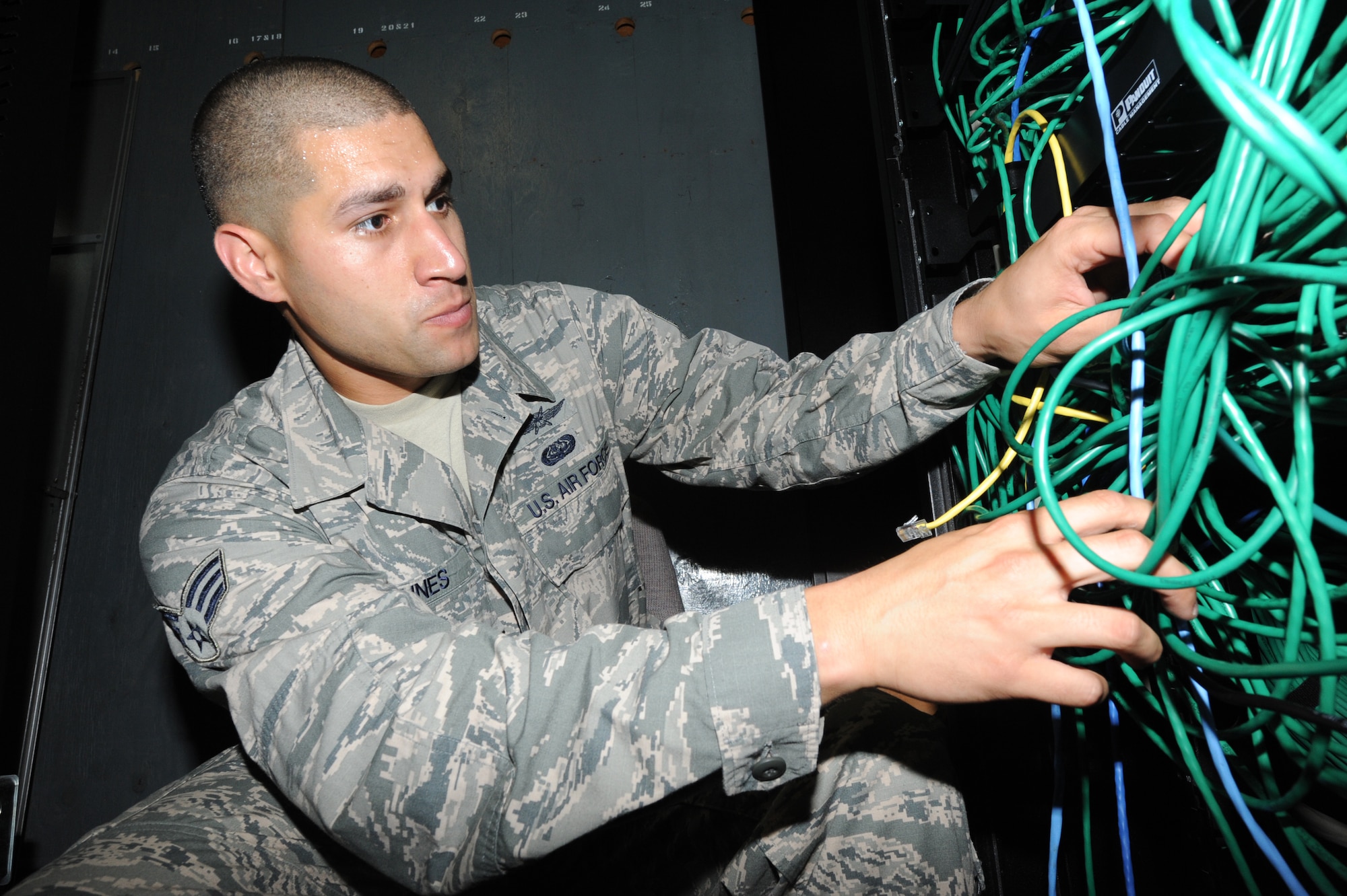 U.S. Air Force Senior Airman Casey Nunes, 733rd Air Mobility Squadron client systems administrator, troubleshoots an infrastructure issue within the squadron on Kadena Air Base, Japan, Sept. 24, 2014. As part of the 733rd AMS's mostly self-sufficient operation, there is a communications flight within them that handles any computer and network related issues. (U.S. Air Force photo by Airmen 1st Class Zackary A. Henry/Released)