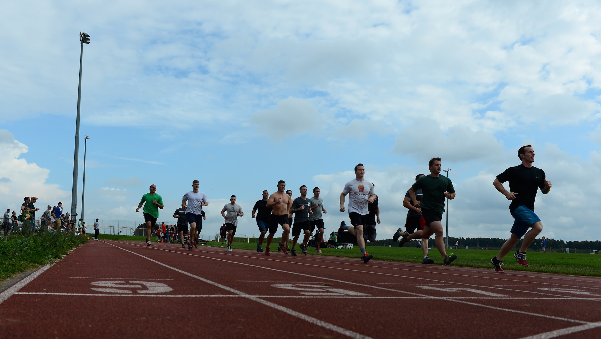 The men’s group of the Combat Fitness Eifel Throwdown start the first of six laps at the outdoor track on Spangdahlem Air Base, Germany, Sept. 20, 2014. Participants ran backwards for two laps as a part of the challenge. (U.S. Air Force photo by Airman 1st Class Luke J. Kitterman) 
