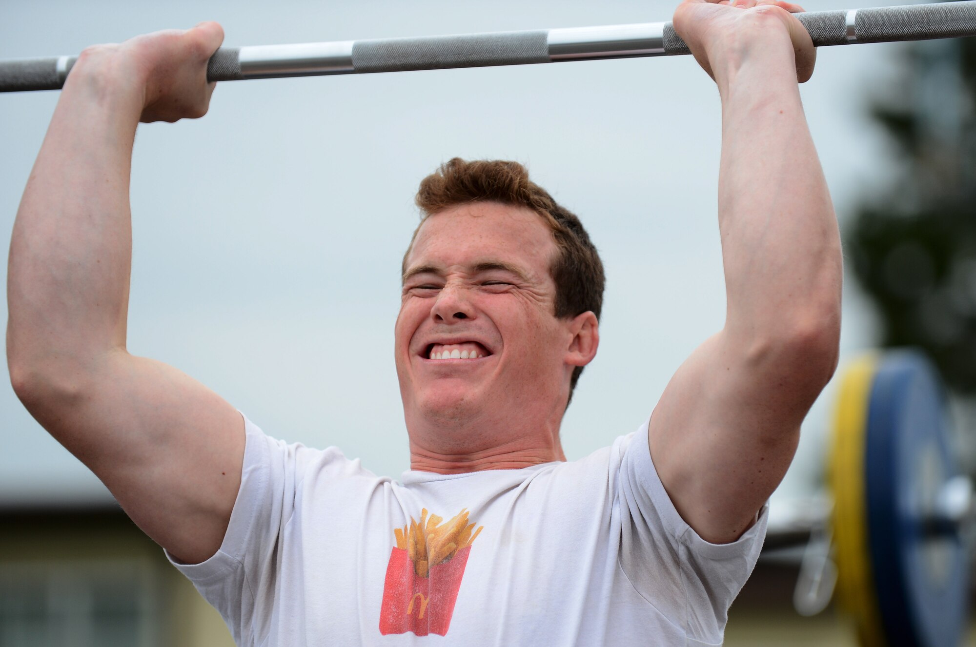 U.S. Air Force Capt. Josh Temple, 480th Fighter Squadron pilot, native of Spokane, Wash.,  pushes a weighted bar above his head while performing Olympic-style lifts at the Combat Fitness Eifel Throwdown on Spangdahlem Air Base, Germany, Sept. 20, 2014. Temple finished in the top 10 of the competition. (U.S. Air Force photo by Airman 1st Class Luke J. Kitterman)  