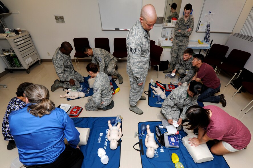 U.S. Air Force medical practitioners receive advanced CPR training on Kadena Air Base, Japan, Sept. 19, 2014. The training covered the proper use of an Automated External Defibrillator, rescue breathing, abdominal thrust techniques and CPR on adults, children and babies. (U.S. Air Force photo by Senior Airman Marcus Morris/Released)