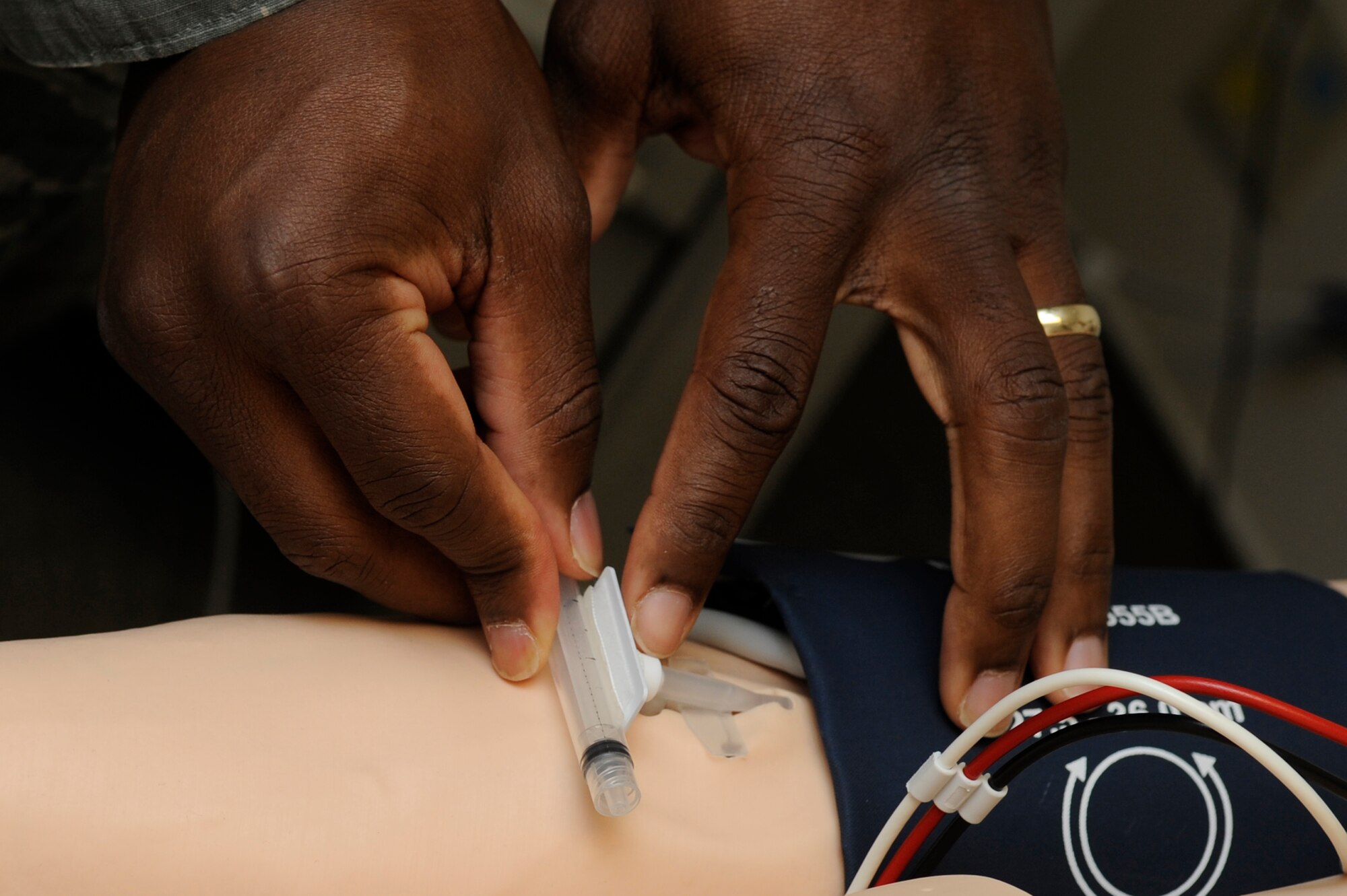 An Airman from the 18th Medical Operations Squadron treats a SimMan 3G advanced patient simulator during “Code Blue” training on Kadena Air Base, Japan, Sept. 18, 2014. Code Blue is usually used for cardiorespiratory emergencies, such as patients who need resuscitation or those who need immediate care. (U.S. Air Force photo by Senior Airman Marcus Morris/Released) 