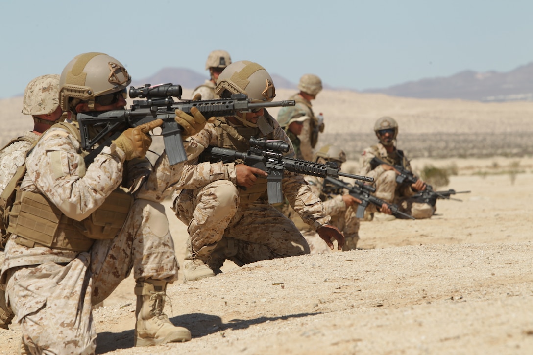 The United Arab Emirates soldiers kneel ready to engage targets on Range 108, Combat Center, training area Sept. 18. This training environment prepared the UAE soldiers to use techniques in similar environments.