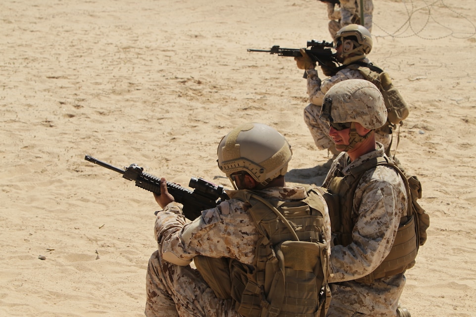 Lance Cpl. Gary Goldman, exercise advisor, 3rd Light Armor Reconnaissance Battalion, watches a United Arab Emirate soldier reload his SIG516 during live-fire training on Range 108, Combat Center training area, Sept. 18. Marines took ample time demonstrating the correct techniques for UAE soldiers, to ensure proper execution and stressed safety on the firing line.