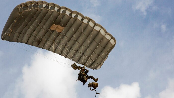 A U.S. Marine Critical Skills Operator with 1st Marine Special Operations Battalion, Marine Corps Forces, Special Operations Command, releases his ruck sack from his body, preparing to land during a double-bag static line parachute training course , Aug 26, 2014, in rural Arizona. The course was an introduction to the High Altitude, High Opening insertion method utilized by Special Operations Forces. 