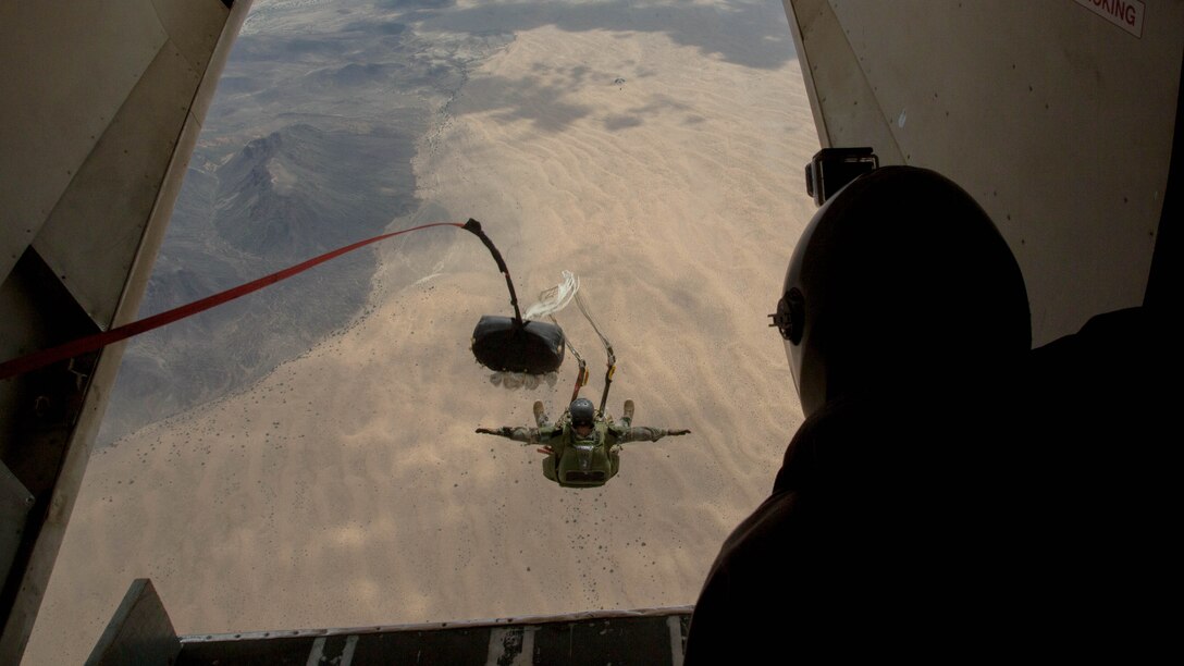 A U.S. Marine Critical Skills Operator with 1st Marine Special Operations Battalion, Marine Corps Forces, Special Operations Command, executes a double-bag static line jump, during a training course , Aug 26, 2014, conducted in rural Arizona.  The course was an introduction to the High Altitude, High Opening insertion method utilized by Special Operations Forces. (U.S. Marine Corps Photo by Lance Cpl. Steven M. Fox/Released)