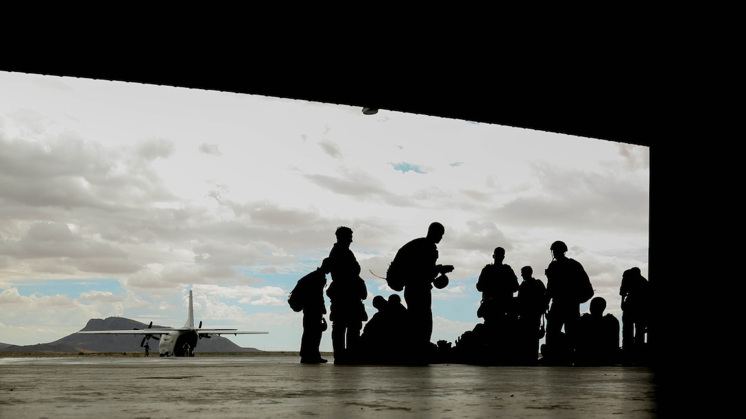 United States Marine critical skills operators with 1st Marine Special Operations Battalion, Marine Corps Forces, Special Operations Command, wait for their double-bag static line parachute training to commence, at a secluded Arizona flightline, Aug 26, 2014.  The course is an introduction to the High Altitude, High Opening insertion method utilized by Special Operations Forces. 