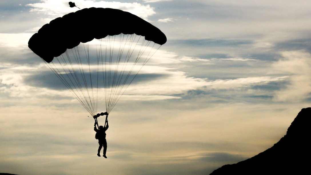 A U.S. Marine Critical Skills Operator with 1st Marine Special Operations Battalion, Marine Corps Forces, Special Operations Command, guides himself to a dropzone in the Arizona desert, during a double-bag static line  parachute training course, Aug 25, 2014. The course was an introduction to the High Altitude, High Opening  insertion method utilized by Special Operations Forces. 