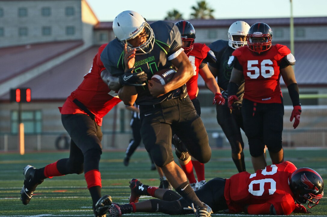 Marine Corps Base Spartans' Mycqwan Nubine scores a touchdown against the Miramar Falcons during a Commanding General's Cup football game at the Paige Fieldhouse football field, Sept. 23. The Spartans defeated the Falcons with a score of 34-0. (Photo by Cpl. Shaltiel Dominguez