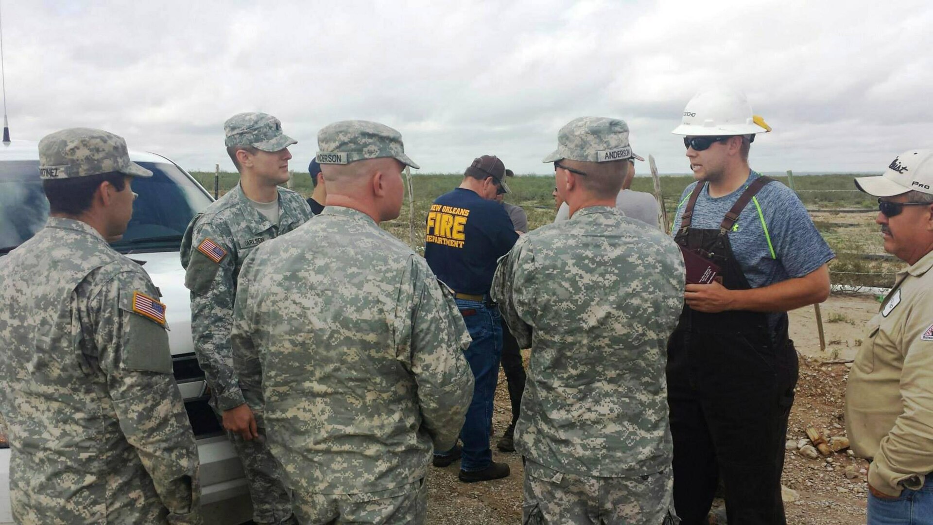 New Mexico National Guard Soldiers and civilian rescuers meet following the Guard's activation to assist following floods late last week.
