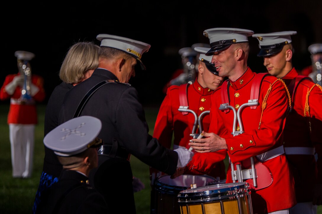 Members of the U.S. Marine Drum & Bugle Corps present a drumstick to Lt. Gen. Robert Milstead, deputy commandant for Manpower and Reserve Affairs, at his retirement ceremony at Marine Barracks Washington, D.C., Sep. 23, 2014. Milstead served his country almost four decades before retiring. (Official Marine Corps photo by Cpl. Dan Hosack/Released)