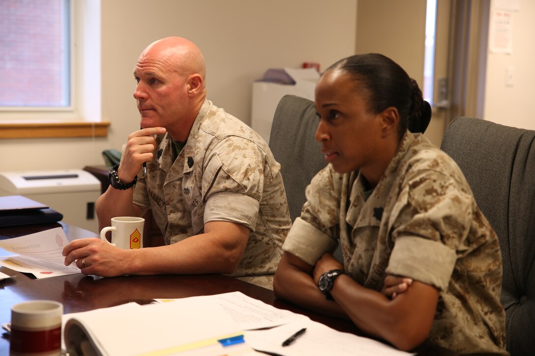 Sgt. Maj. of the Marine Corps Micheal P. Barrett is accompanied by Sgt. Maj. Robin C. Fortner, sergeant major, Ground Combat Element Integrated Task Force, during a visit to the GCEITF headquarters, Sept. 23, 2014. Barrett was formally briefed on statistics and organization by senior enlisted leaders in the unit. From October 2014 to July 2015, the GCEITF will conduct individual and collective level skills training in designated ground combat arms occupational specialties in order to facilitate the standards based assessment of the physical performance of Marines in a simulated operating environment performing specific ground combat arms tasks. (Marine Corps photo by Cpl. Paul S. Martinez/Released)