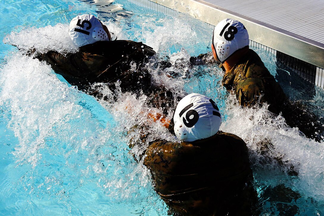 More than 50 Marines from various units came together to compete in the Combat Water Polo Tournament at the 13 Area pool, here, Sept. 24. The teams were comprised of seven to 10 Marines, each wearing boots and utilities while trying to claim first place.
