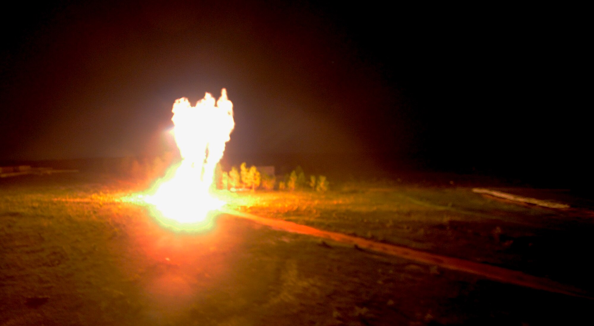 An AC-130U gunship round impacts a training target during a capabilities demonstration on Alpha 77 Range, Eglin Reservation, Fla., Sept. 19, 2014. Hurlburt Field Honorary Commanders witnessed the capabilities of the AC-130U Spooky Gunship, and how ground forces call for fire in a hostile situation. (U.S. Air Force photo/Staff Sgt. Sarah Hanson)