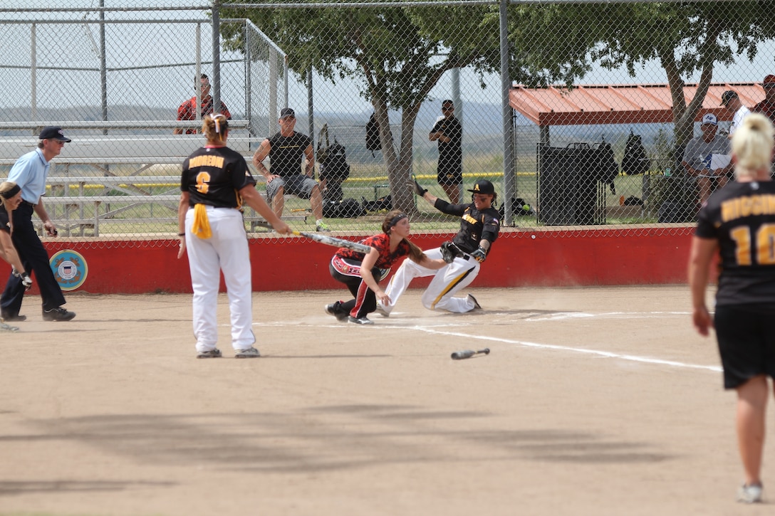 Army Sgt. Leina Braxton slides in for the score against Marine Corps at the 2014 Armed Forces Softball Championship at Fort Sill, Okla. 14-19 Sept.