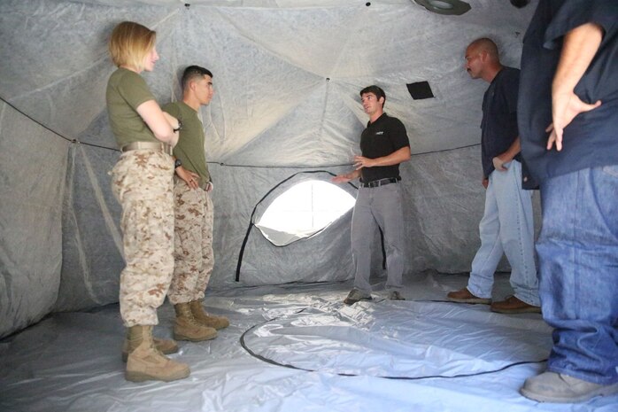 Marines and civilian contractors stand inside an Arctic shelter Aug. 29, 2014, aboard Camp Pendleton, California. The system is an ultra-lightweight, rapidly deployable shelter that offers military forces the necessary infrastructure to operate in austere cold-weather locations. The system is being used for training exercises in Bridgeport, California, and is slated to be integrated into exercises early next year. 