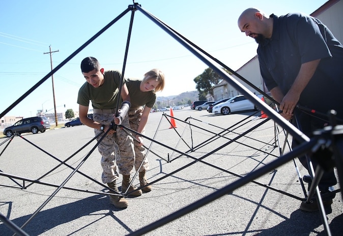 Marines and civilian contractors put together an Arctic shelter Aug. 29, 2014, aboard Camp Pendleton, California. The system is an ultra-lightweight, rapidly deployable shelter that offers military forces the necessary infrastructure to operate in austere cold-weather locations. The system is being used for training exercises in Bridgeport, California, and is slated to be integrated into exercises early next year. 