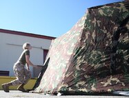 Private Sarah Trull, a fiscal clerk with Marine Air Group 39, puts together an Arctic shelter Aug. 29, 2014, aboard Camp Pendleton, California. The system is an ultra-lightweight, rapidly deployable shelter that offers military forces the necessary infrastructure to operate in austere cold-weather locations. The system is being used for training exercises in Bridgeport, California, and is slated to be integrated into exercises early next year. 