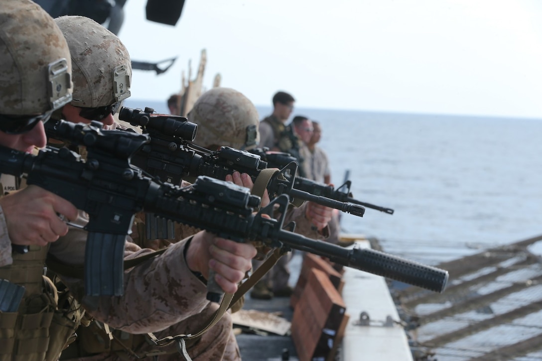 U.S. Marines with the scout sniper platoon, Battalion Landing Team 2nd Battalion, 1st Marines, 11th Marine Expeditionary Unit (MEU), fire at targets from the rear of the flight deck of the amphibious transport dock ship USS San Diego (LPD 22) while underway. San Diego is part of the Makin Island Amphibious Ready Group and, with the embarked 11th MEU, is deployed in support of maritime security operations and theater security cooperation efforts in the U.S. 5th Fleet area of responsibility. (U.S. Marine Corps photo by Cpl. Jonathan R. Waldman/Released)