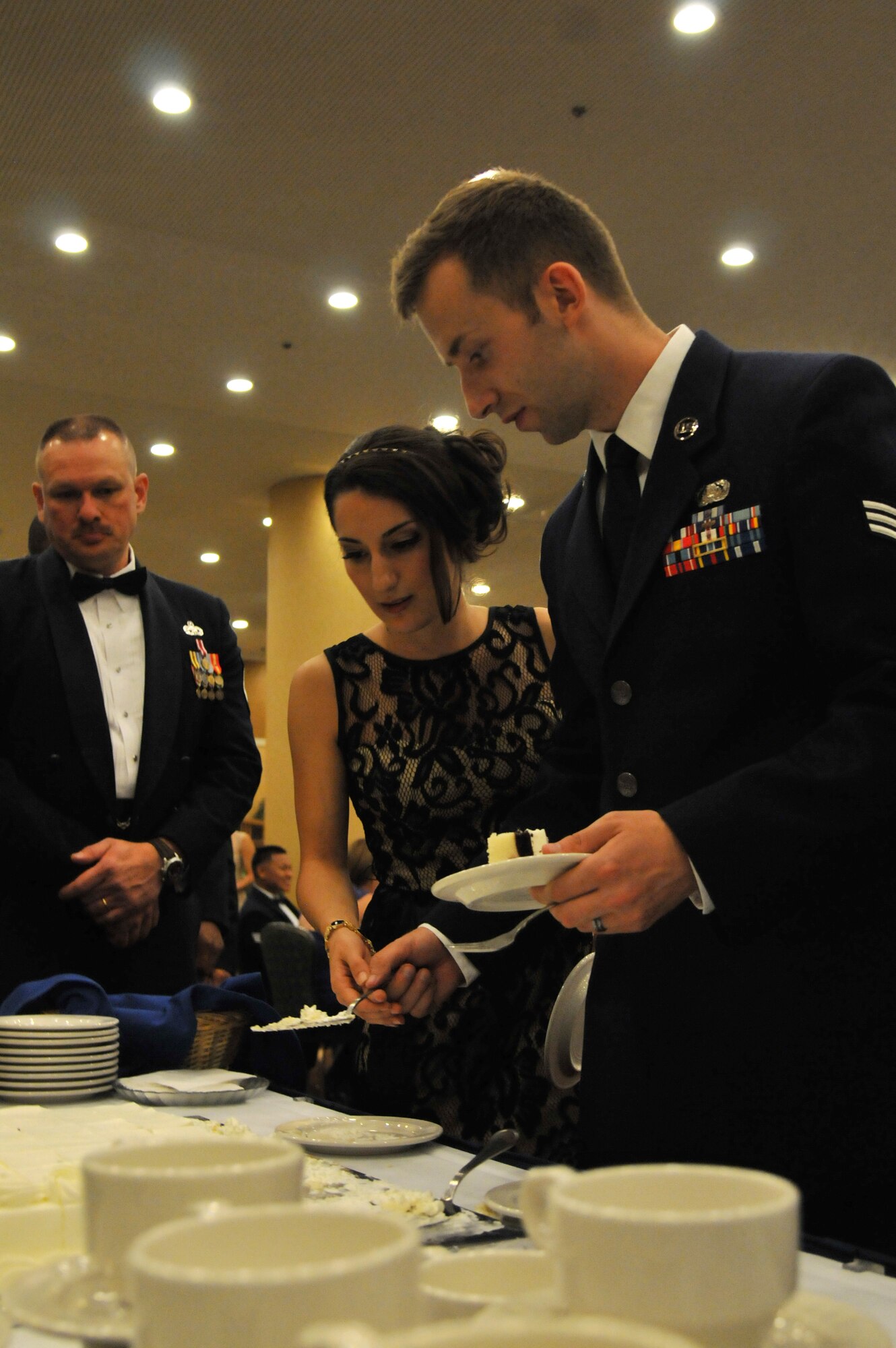 U.S. Air Force Senior Airman Brandon Roush, 35th Communications Squadron postal clerk, and his spouse, cut a piece of cake during the 67th Annual Air Force Ball at Misawa Air Base, Japan, Sept. 20, 2014. The ball had more than 400 individuals in attendance. (U.S. Air Force photo by Senior Airman Jose L. Hernandez-Domitilo/Released)