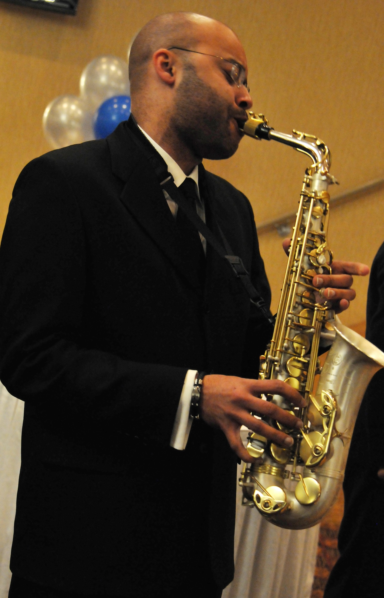 Special Agent Talfred Collins plays a rendition of the United States national anthem during the 67th Annual Air Force Ball at Misawa Air Base, Japan, Sept. 20, 2014. Collins soloed both the Japanese and American anthems as part of the opening ceremony. (U.S. Air Force photo by Senior Airman Jose L. Hernandez-Domitilo/Released)