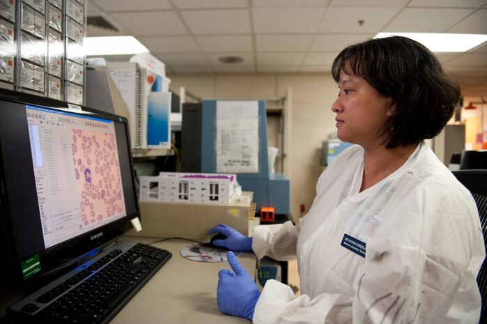 Vivian Candelario, 99th Medical Support Squadron medical laboratory technician, looks at cells on a computer at the Mike O’Callaghan Federal Medical Center at Nellis Air Force Base, Nev., Sept. 19, 2014. The laboratory staff preforms approximately 1.1 million tests per year and serves more than 49,000 enrolled beneficiaries. (U.S. Air Force photo by Airman 1st Class Thomas Spangler)