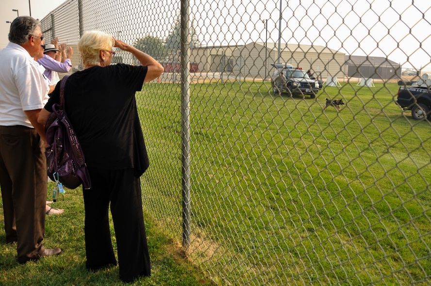 Honorary commanders Darlene Hunt and Ron Bartoli witness a military working dog in training during a base tour Sept. 22, 2014, at Beale Air Force Base, Calif.  The honorary commander program connects civic leaders with Air Force commanders to foster working relationships. (U.S. Air Force photo by Staff Sgt. Brenda Davis/Released)