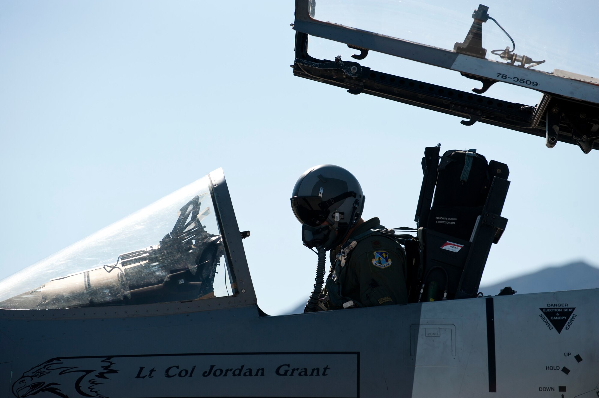 Maj. Sam Joplin, 122nd Fighter Squadron, Naval Air Station Joint Reserve Base New Orleans, F-15 Eagle pilot, preforms a pre-flight check before flying a 65th Aggressor Squadron F-15 at Nellis Air Force Base, Nev., Sept. 18, 2014. The 65th AGRS will be inactivating on Sept. 26, 2014. After the 65th AGRS is inactivated, the unit's assigned aircraft will be transferred to Air National Guard bases. The remaining 65th AGRS pilots will continue their mission under the 64th AGRS until March 2015. (U.S. Air Force photo by Airman 1st Class Thomas Spangler)