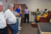 Senior Airman Tamika Bedasie, 9th Physiological Support Squadron, demonstrates the full-pressure suit worn by U-2 pilots Sept. 22, 2014, at Beale Air Force Base, Calif.  Civic leaders toured the base as part of the honorary commander program.  (U.S. Air Force photo by Staff Sgt. Brenda Davis/Released)