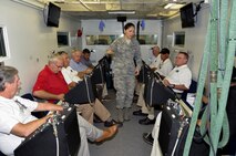 Airman 1st Class Soreya Moun, 9th Physiological Support Squadron, explains training conducted in the altitude chamber Sept. 22, 2014, at Beale Air Force Base, Calif.  Honorary commanders are local civic leaders who are paired with Air Force commanders to help strengthen connections with the community. (U.S. Air Force photo by Staff Sgt. Brenda Davis/Released)