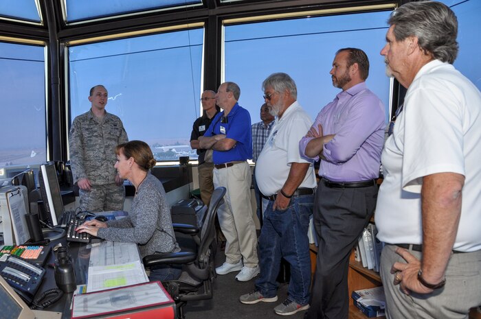 Senior Airman Tyson Foster, 9th Operation Support Squadron air traffic controller, explains to honorary commanders how the tower manages the airspace to keep operations running smoothly Sept. 22, 2014, at Beale Air Force Base, Calif.  The civic leaders were touring the base to foster and strengthen community connections.   (U.S. Air Force photo by Staff Sgt. Brenda Davis/Released)
