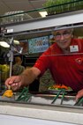 Dennis Roberts, 9th Maintenance Group honorary commander, builds a salad at Contrails Dining Facility Sept. 22, 2014, at Beale Air Force Base, Calif.  Roberts toured the base with other civic leaders and Air Force commanders. (U.S. Air Force photo by Staff Sgt. Brenda Davis/Released) 