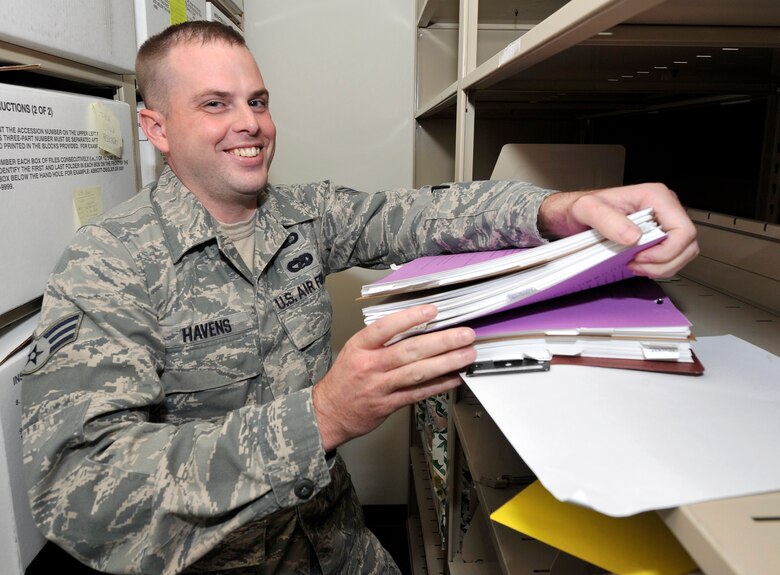 Senior Airman John Havens, reviews contracts from the file cabinet at Fairchild Air Force Base, Washington, Sept. 24, 2014. Havens is with the 92nd Contracting Squadron and has been selected as a member of Team Fairchild’s elite, Fairchild’s Finest. (U.S. Air Force photo by Senior Airman Ryan Zeski/Released)