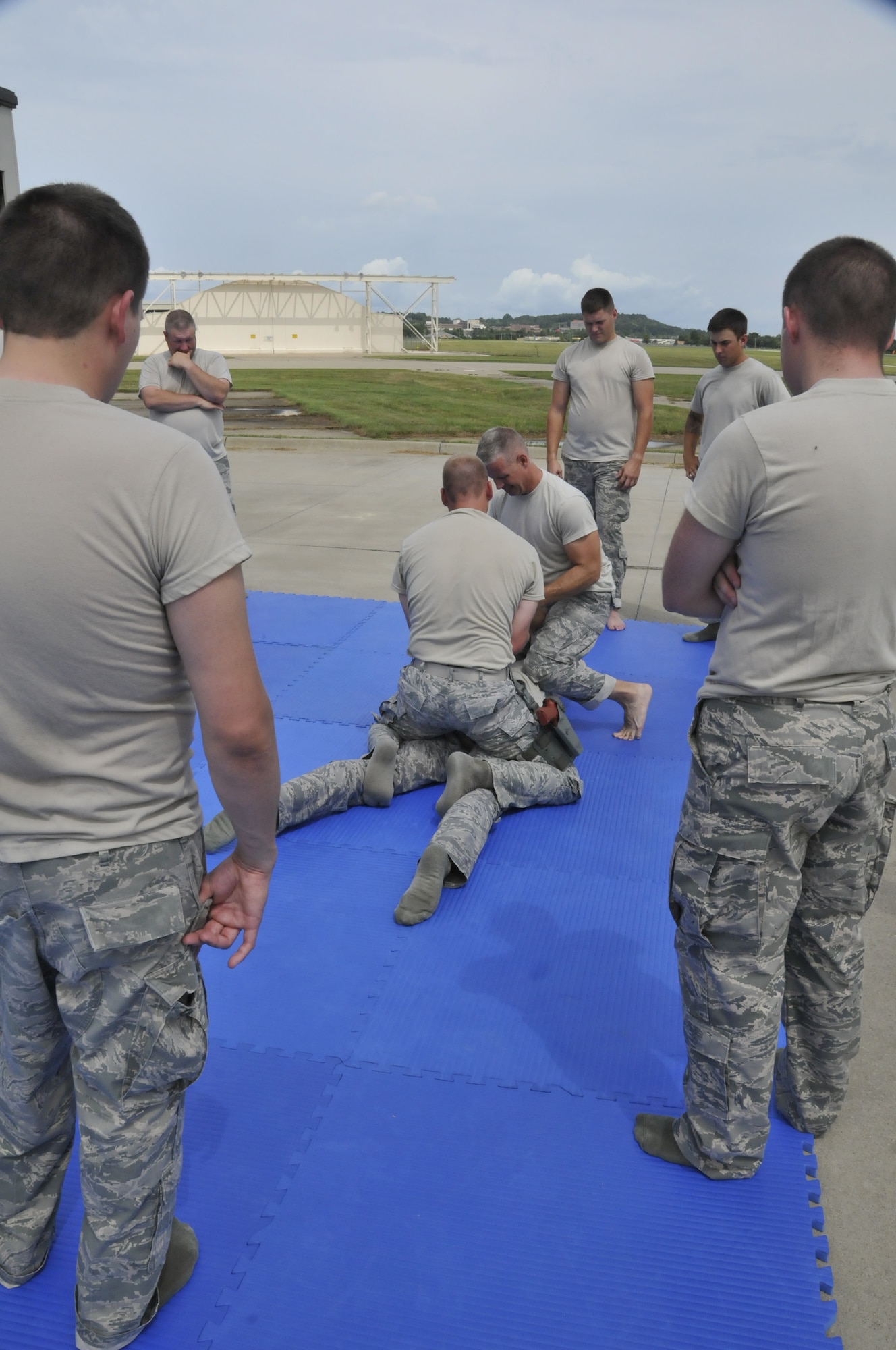Members of the 188th Security Forces Squadron watch as two combative instructors, Tech. Sgt. Tim Holland and Tech. Sgt. Bradley Hobbs, demonstrate an immobilizing technique in a training event held at Ebbing Air National Guard Base, Fort Smith, Arkansas on Sept. 6, 2014. The event, held during a unit training assembly, strengthened the squadron’s mission readiness. (U.S. Air National Guard photo by Staff Sgt. John Suleski/Released)