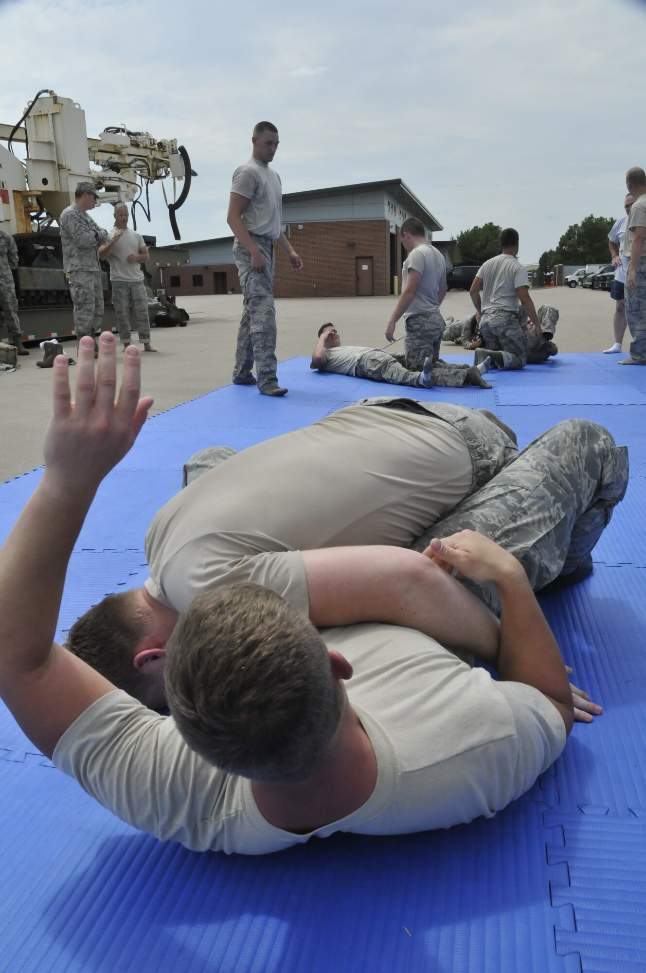 Members of the 188th Security Forces Squadron perform various combative moves in a training event held at Ebbing Air National Guard Base, Fort Smith, Arkansas Sept. 6, 2014. The event, held during a unit training assembly, strengthened the squadron’s mission readiness. (U.S. Air National Guard photo by Staff Sgt. John Suleski/Released)