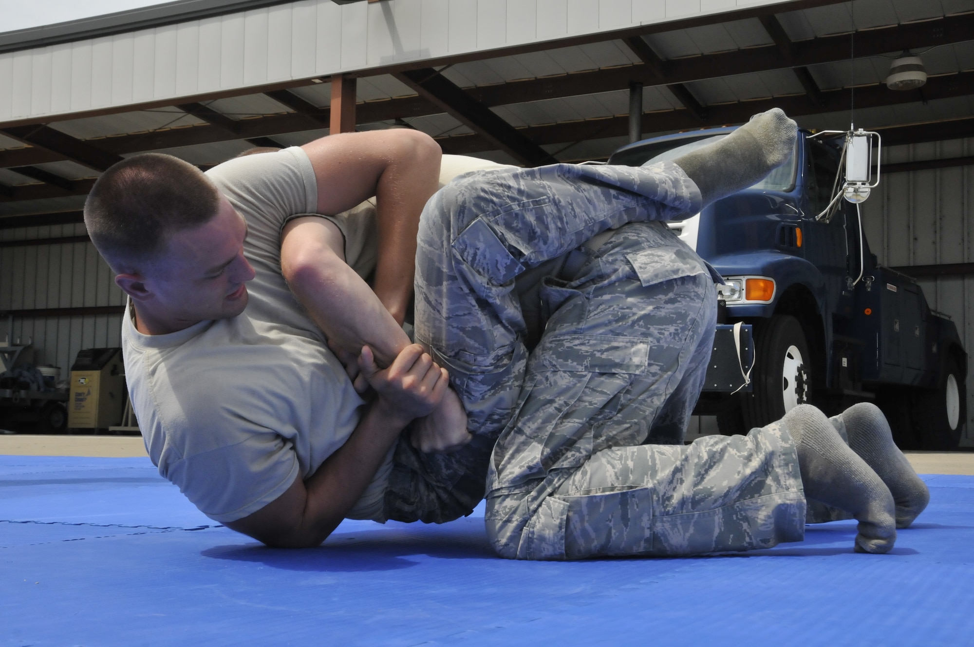 Senior Airman Mason Redding, 188th Security Forces Squadron security forces specialist (left), practices a combative technique on another member of the squadron in a training event held at Ebbing Air National Guard Base, Fort Smith, Arkansas on Sept. 6, 2014. The event, held during a unit training assembly, strengthened the squadron’s mission readiness.  (U.S. Air National Guard photo by Staff Sgt. John Suleski/Released)