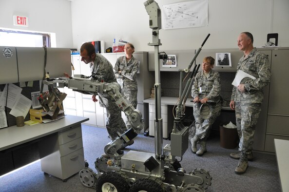 Observers from the 442d Fighter Wing watch an EOD robot disables a booby trap during an exercise at Whiteman AFB, Mo. on September 21. The exercise combined five functional capabilities from the wing including security forces, fire fighters, EOD, emergency management and bioenvironmental. (Air Force photo by Tech. Sgt. Emily F. Alley)