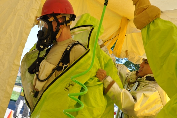 Members of the 442d Fighter Wing fire department remove equipment after simulating a containment of toxic materials from near a ricin lab during an exercise at Whiteman AFB, Mo. September 21. The exercise combined players from five functional areas- security forces, fire fighters, EOD, emergency management and bioenvironmental - within the wing and was the first to build a scenario on such a large scale. (Air Force photo by Tech. Sgt. Emily F. Alley)