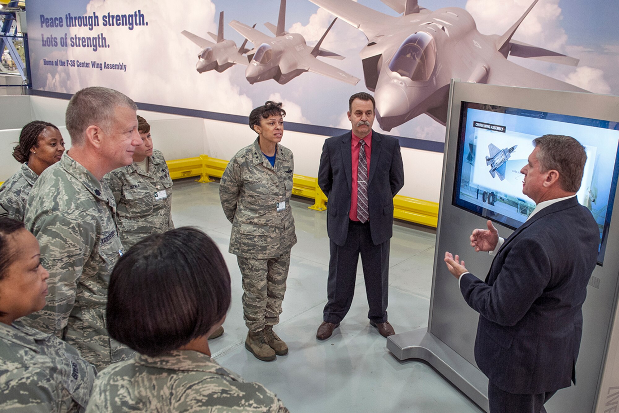 Tim Webster, Lockheed Martin (Plant 6) F-35 director, gives Maj. Gen. Stayce Harris, 22nd Air Force commander, and nine unit members an overview of the aircraft's assembly during a tour of the production facilities Sept. 19, 2014. Representatives from Lockheed Martin discussed current and future  programs, as well as its ongoing partnership with Dobbins Air Reserve Base. (Photo by John Rossino)