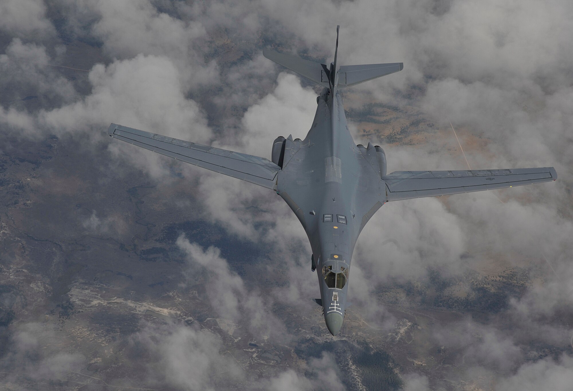 A B-1B Lancer assigned to Ellsworth Air Force Base, South Dakota, soars through the sky after participating in an aerial refueling training mission over South Dakota, Sept. 23, 2014. The B-1Bs blended wing/body configuration, variable-geometry wings and turbofan afterburning engines, combine to provide long range, maneuverability and high speed while enhancing survivability. (U.S. Air Force photo by Senior Airman Mary O'Dell/Released)